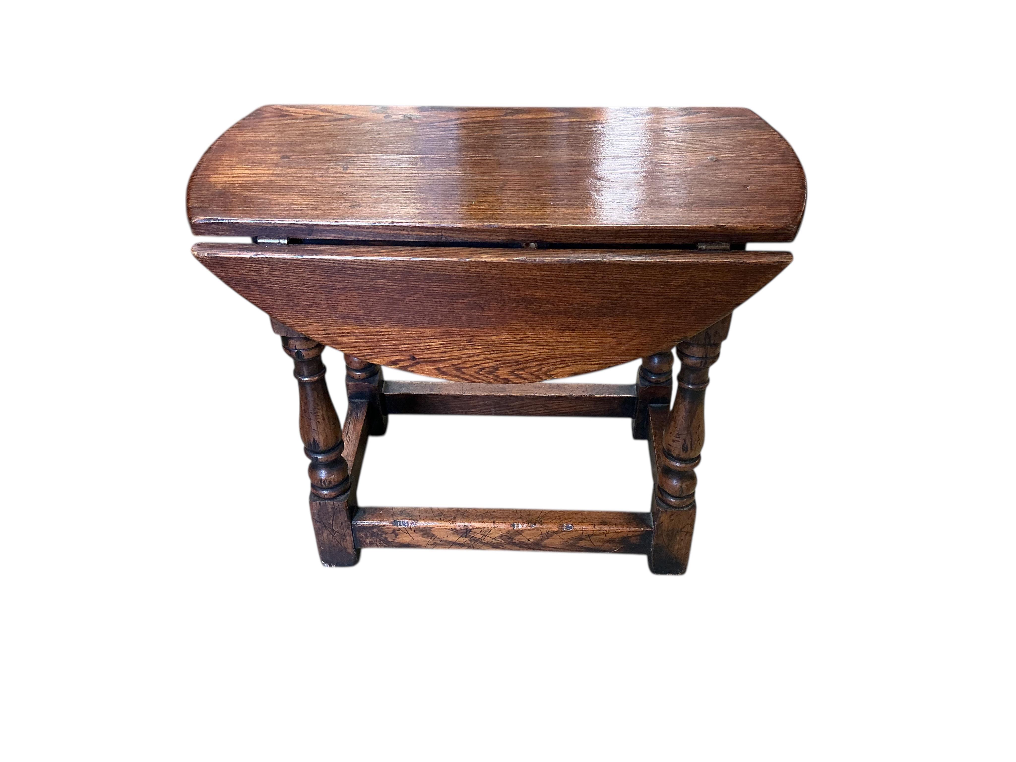 Two 17th century style rectangular oak joint stools, larger width 48cm, depth 31cm, height 53cm, together with a later oak drop flap occasional table